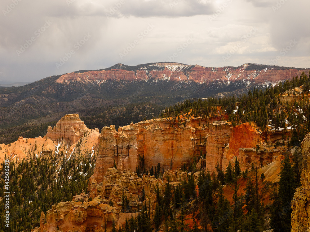 Fototapeta premium Bryce Canyon National Park, a sprawling reserve in southern Utah, is known for crimson-colored hoodoos, which are spire-shaped rock formations.
