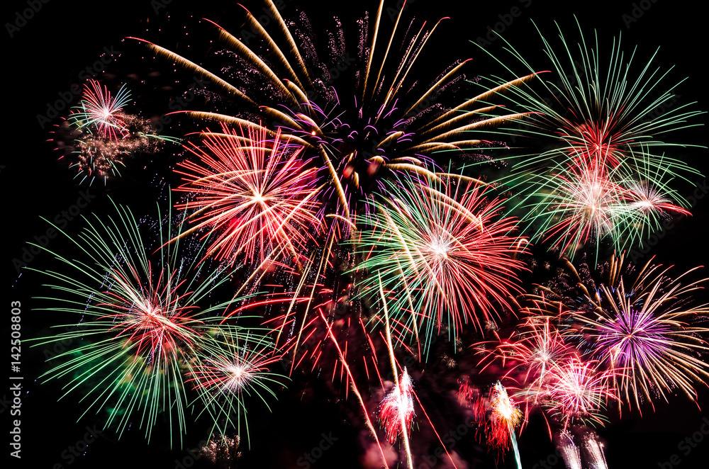 Fireworks lit up beautifully and filled the dark black sky with gold, red, pink, green, white light at night time to celebrate new year eve, festival, fourth of July, and special occasion Fireworks lit up beautifully and filled the dark black sky with gold, red, pink, green, white light at night time to celebrate new year eve, festival, fourth of July, and special occasion
