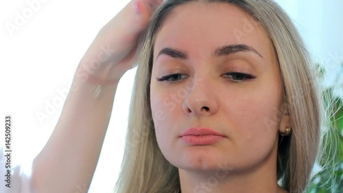 Wallpaper Mural Cosmetologist washes away paint from eyebrows a wadded disk. End of the procedure. Torontodigital.ca