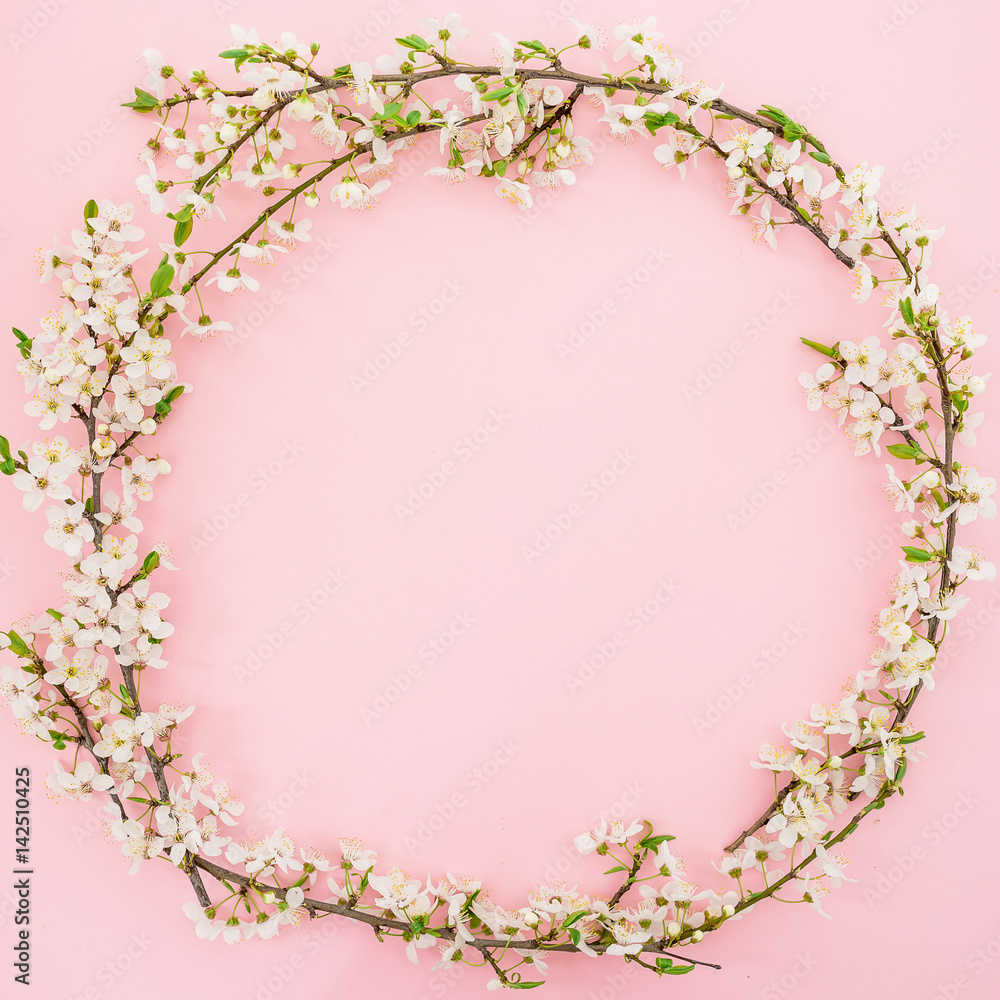 Frame of spring flowers isolated on pink background. Flat lay, top view. Spring time background.