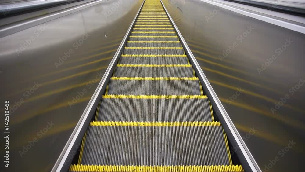 The downward movement standing on an empty escalator The downward movement standing on an empty escalator