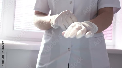 Wallpaper Mural Doctor wearing glove in hospital. Medical gloves. Healthcare worker putting on medical gloves. Women doctor wearing latex glove. Close-up Torontodigital.ca