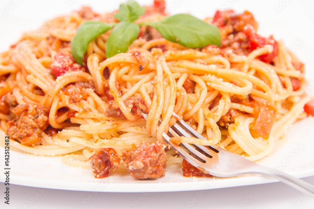 Spaghetti bolognese being eaten with a fork Spaghetti bolognese being eaten with a fork