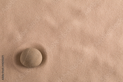 zen stone minimal background for yoga, meditation or relaxation. Meditation rock in sand with copy space.