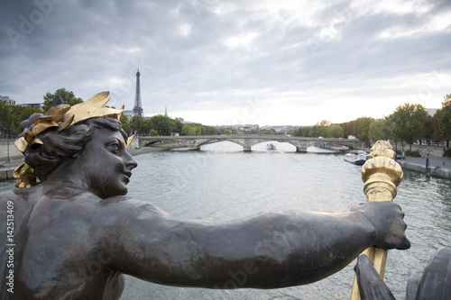Figure on the Alexandre III Bridge looking towards the Eiffel Tower, Paris, France © kevers