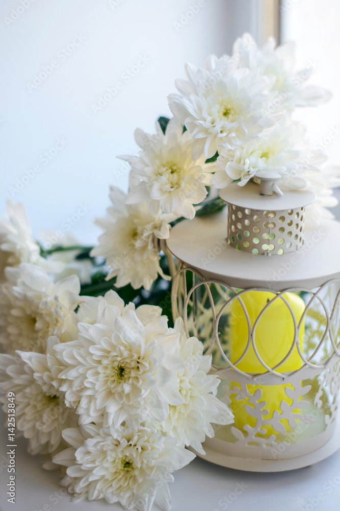 delicate decor of the candlestick and chrysanthemums, selective focus