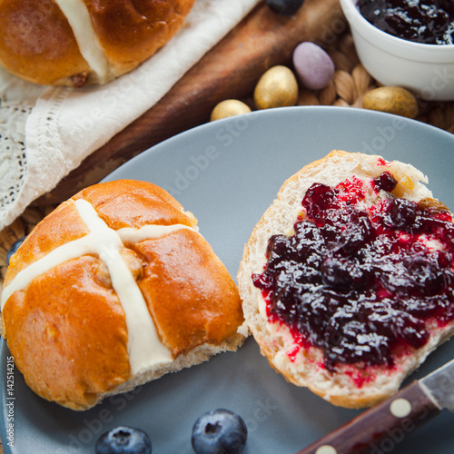 Easter sweet Hot Cross Buns derved with butter and jam - delicious teatime treat. photo