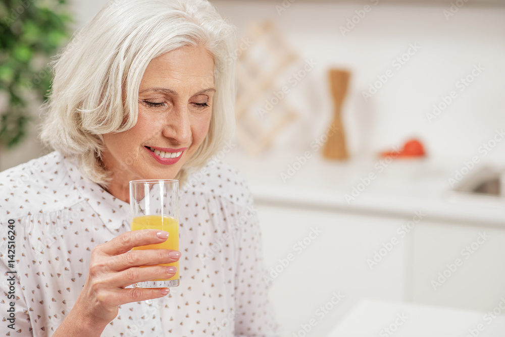 Joyful mature housewife caring of her health Joyful mature housewife caring of her health