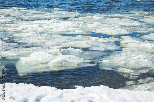 lots of ice floes floating in the river