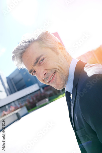 Portrait of mature businessman walking outside