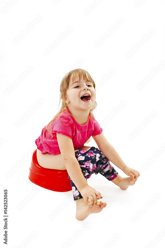 Little girl sitting on a chamber pot. Isolated on white background Little girl sitting on a chamber pot. Isolated on white background