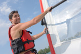 handsome young windsurfer on the water