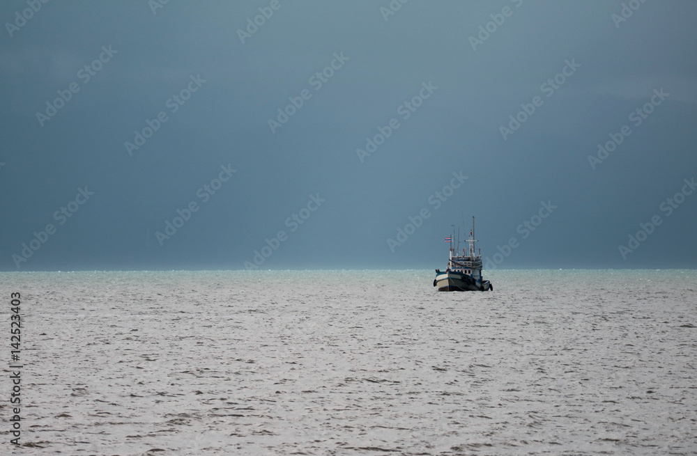 One fishing boat sailing under the stormy sky, Gulf of Thailand One fishing boat sailing under the stormy sky, Gulf of Thailand