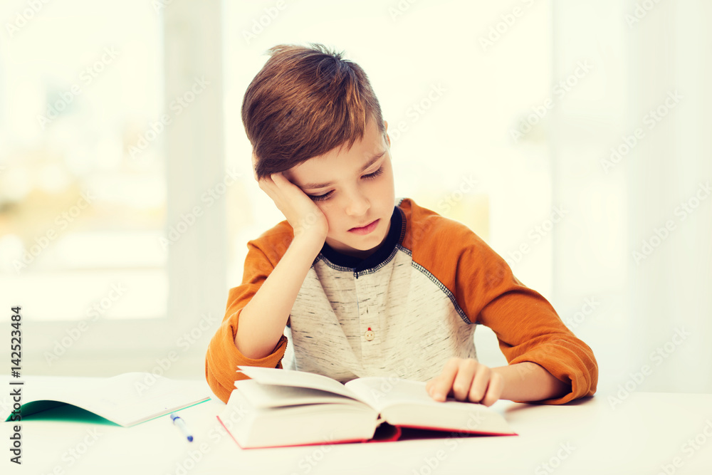 student boy reading book or textbook at home student boy reading book or textbook at home