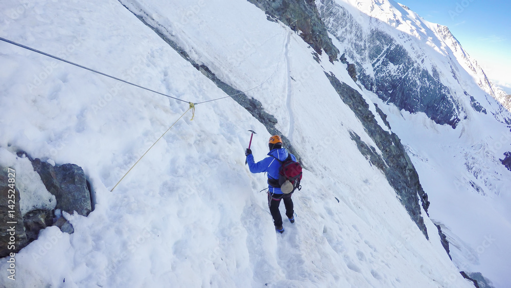 Mountaineer arrive at Couloir passage on the way to the Montblanc summit. Concepts: determination, courage, effort, self-realization. Sunny winter day, european Alp Mountaineer arrive at Couloir passage on the way to the Montblanc summit. Concepts: determination, courage, effort, self-realization. Sunny winter day, european Alp