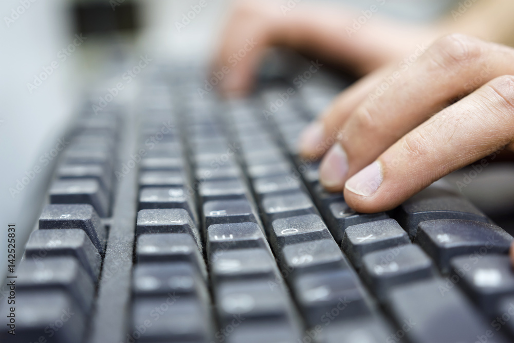 Hands of an office operator typing on dirty keyboard, a virus carrier that transmits diseases. Dof copyspace background