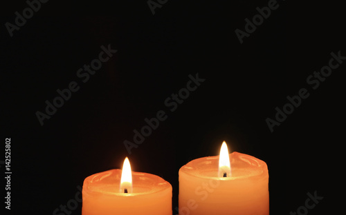 Burning Pair of Orange Candles On Black Background 