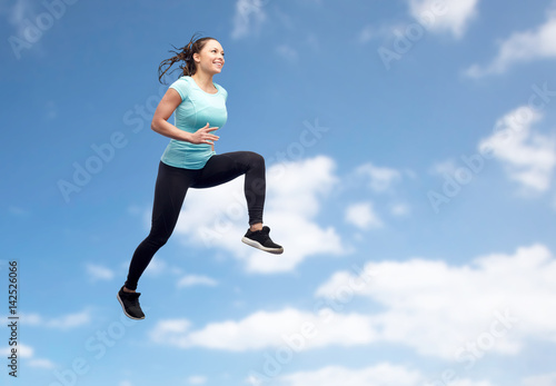 happy smiling sporty young woman jumping in air © Syda Productions