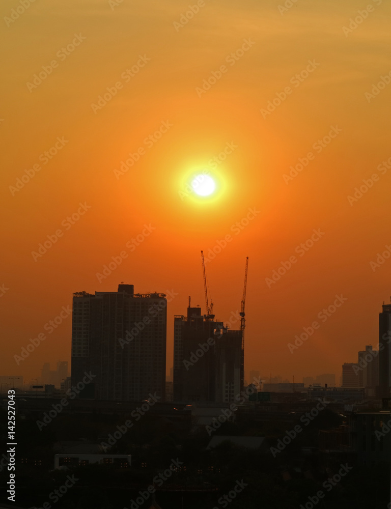 Naklejka premium Stunning sunset over the constructing buildings at the Suburbs of Bangkok, Thailand, vertical image 