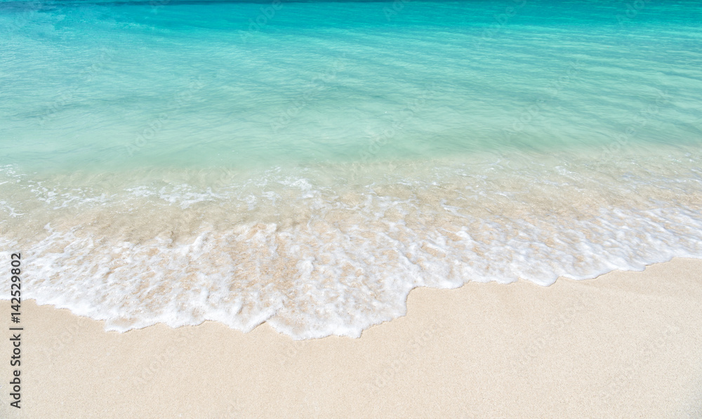 wavy sea, ocean water background on sand coast in Antigua