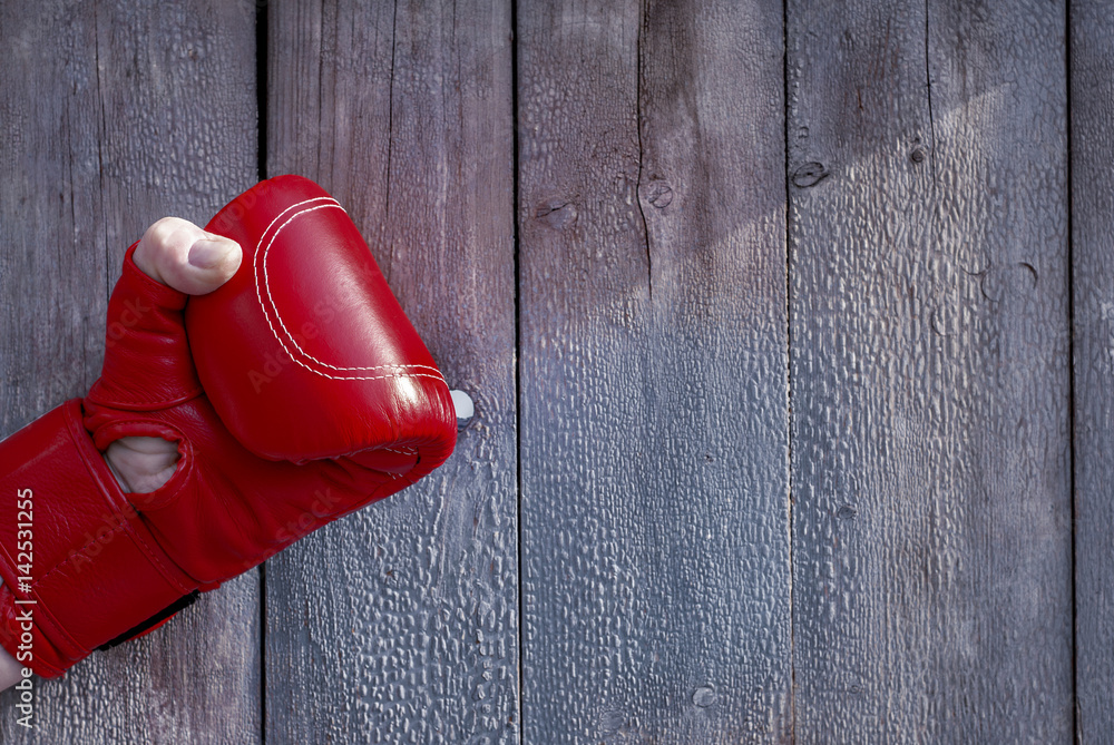 Right man's hand in red boxing gloves