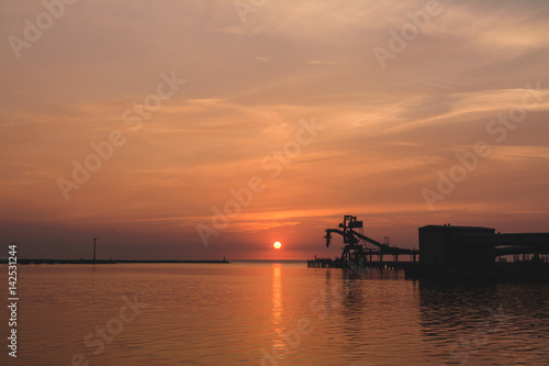 Ship loader sunset silhouette