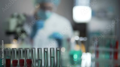 Experienced virologists conducting screening of blood samples to invent vaccine