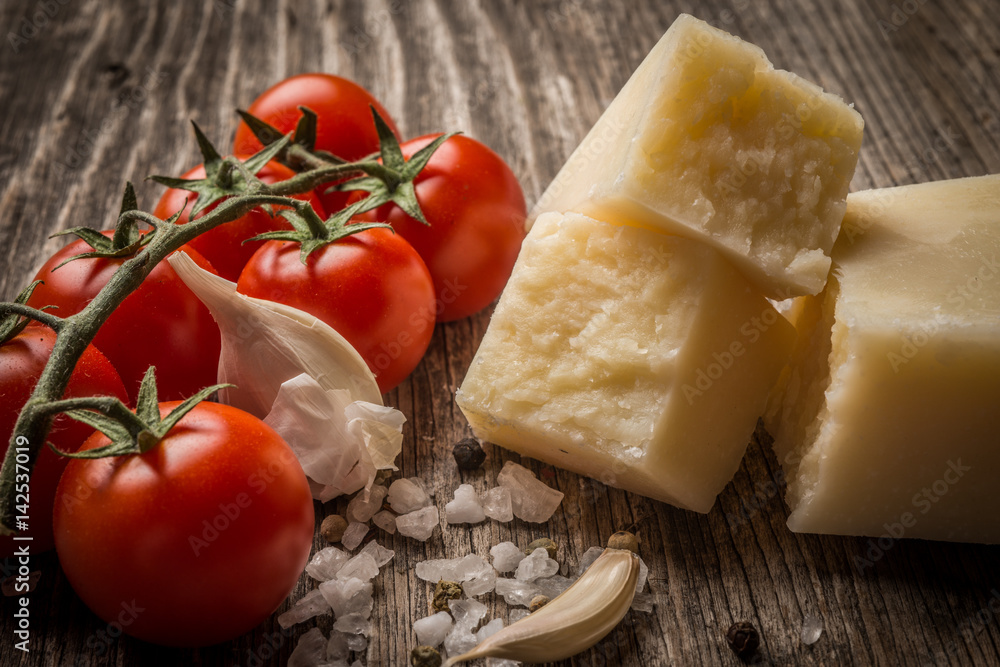 Pecorino and cherry tomatoes on rustic wooden table Pecorino and cherry tomatoes on rustic wooden table
