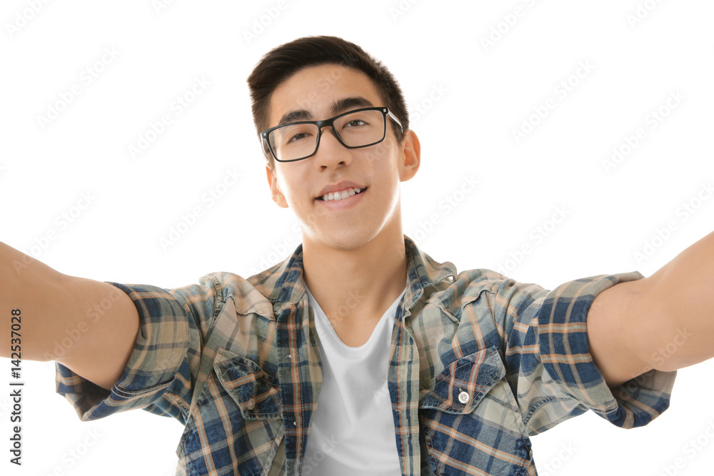 Young Asian man taking selfie on white background Young Asian man taking selfie on white background