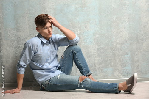 Handsome young man sitting ...