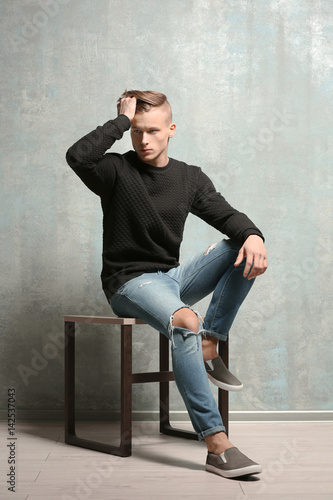 Handsome young man sitting ...