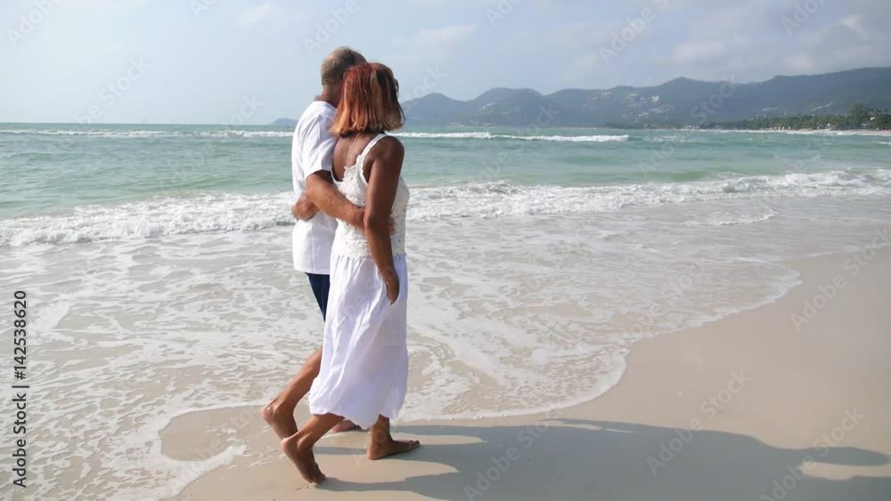 Middle Aged Couple Walking on Beach. Slow Motion. Middle Aged Couple Walking on Beach. Slow Motion.