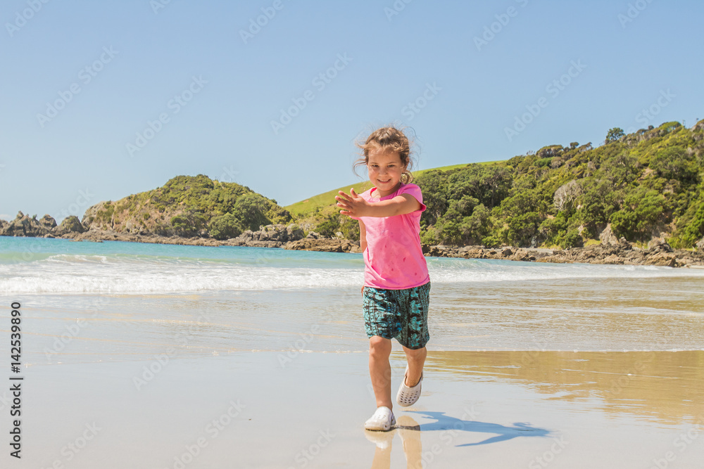 outdoor portrait of young happy smiling child girl playing run on beach outdoor portrait of young happy smiling child girl playing run on beach