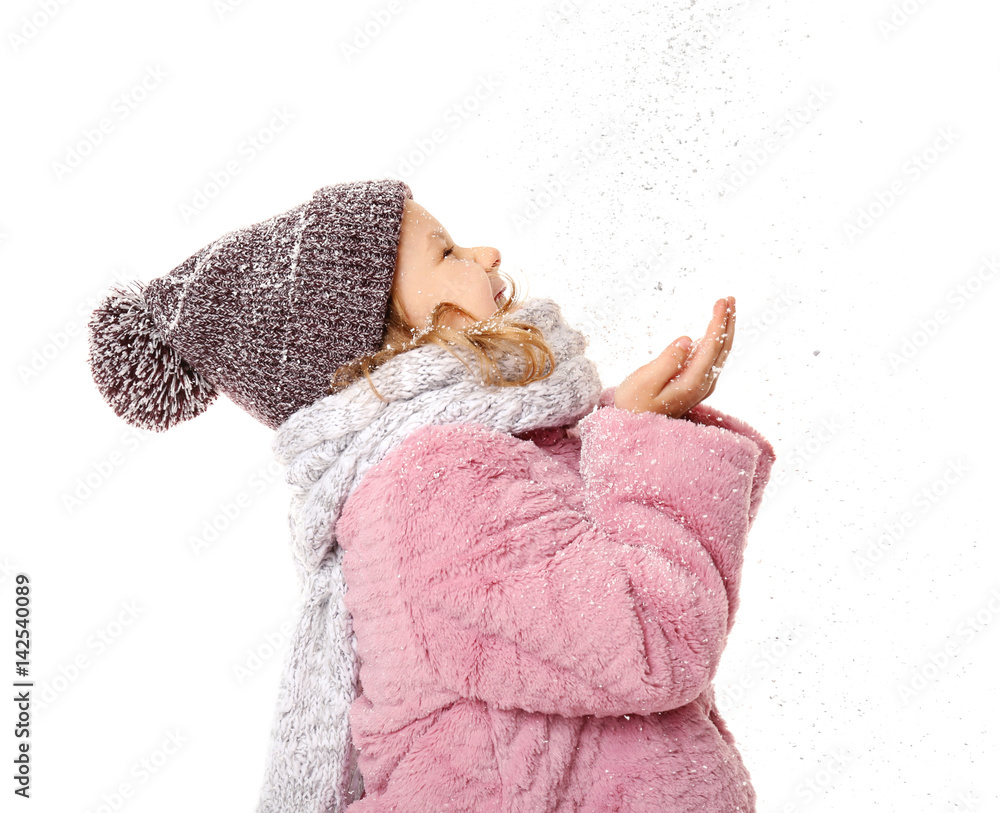 Cute little girl in warm clothes playing with snow on white background Cute little girl in warm clothes playing with snow on white background