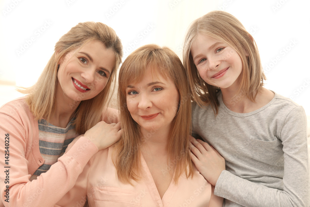 Happy young woman with her mother and daughter at home Happy young woman with her mother and daughter at home