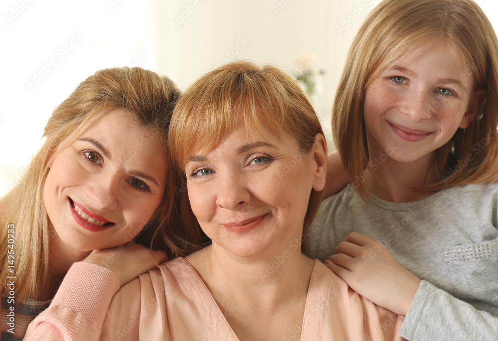 Happy young woman with her mother and daughter at home Happy young woman with her mother and daughter at home