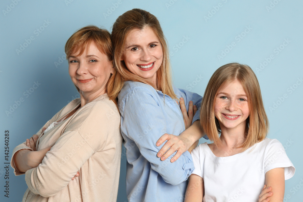 Happy young woman with her mother and daughter on color background Happy young woman with her mother and daughter on color background