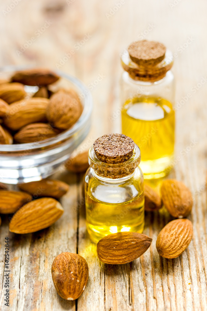 cosmetic and therapeutic almond oil on wooden background cosmetic and therapeutic almond oil on wooden background