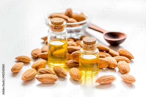 cosmetic set with almond oil on light table background