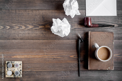 writer workplace with tools on wooden background top view mockup