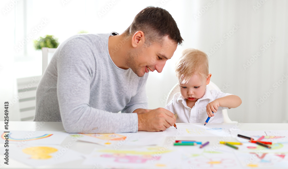 father and baby son paint together