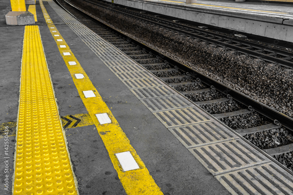 Fototapeta premium Yellow line for security line made from arise rubber for blind people in train station photo taken in Jakarta Indonesia