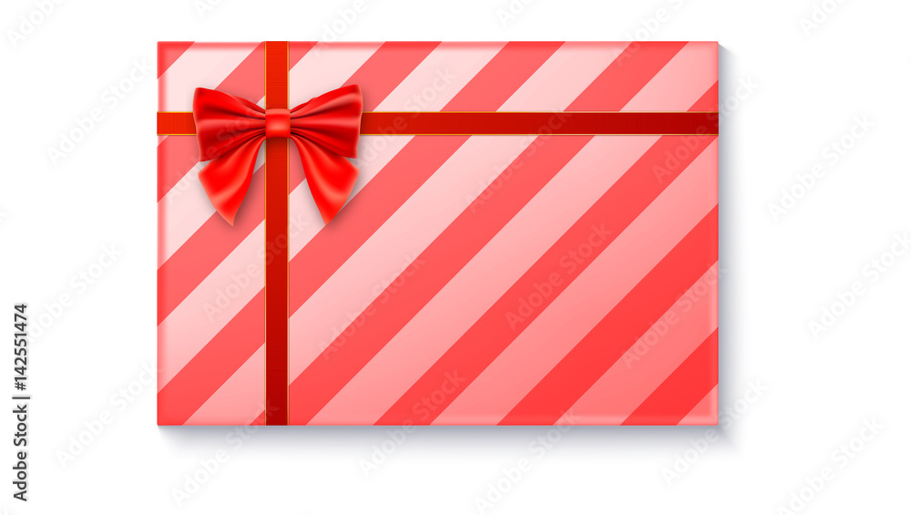 Gift box with big red bow and ribbon, isolated on white background. Top view on gift packaged in a paper with pattern Gift box with big red bow and ribbon, isolated on white background. Top view on gift packaged in a paper with pattern