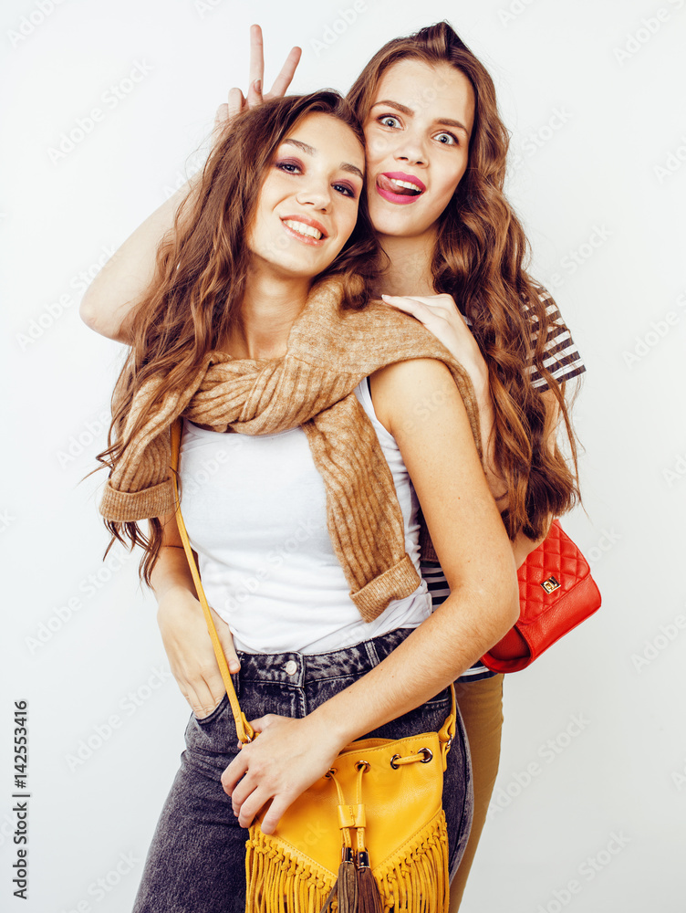 lifestyle and people concept: Fashion portrait of two stylish sexy girls best friends, over white background. Happy time for fun. lifestyle and people concept: Fashion portrait of two stylish sexy girls best friends, over white background. Happy time for fun.
