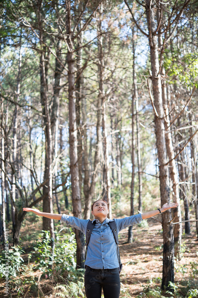 Young hipster happy woman enjoy nature in forest with outstretched arms. Young hipster happy woman enjoy nature in forest with outstretched arms.