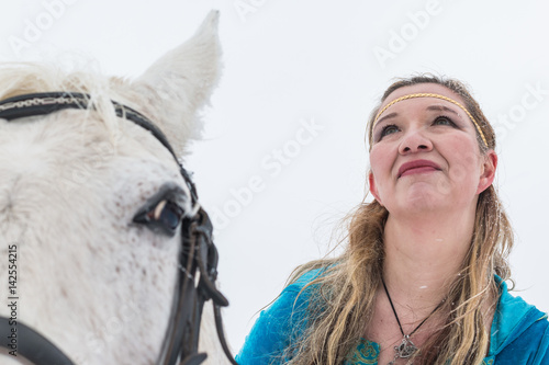 Woman in national dress and horse