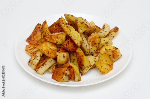 fried potato with spiced on white plate isolated