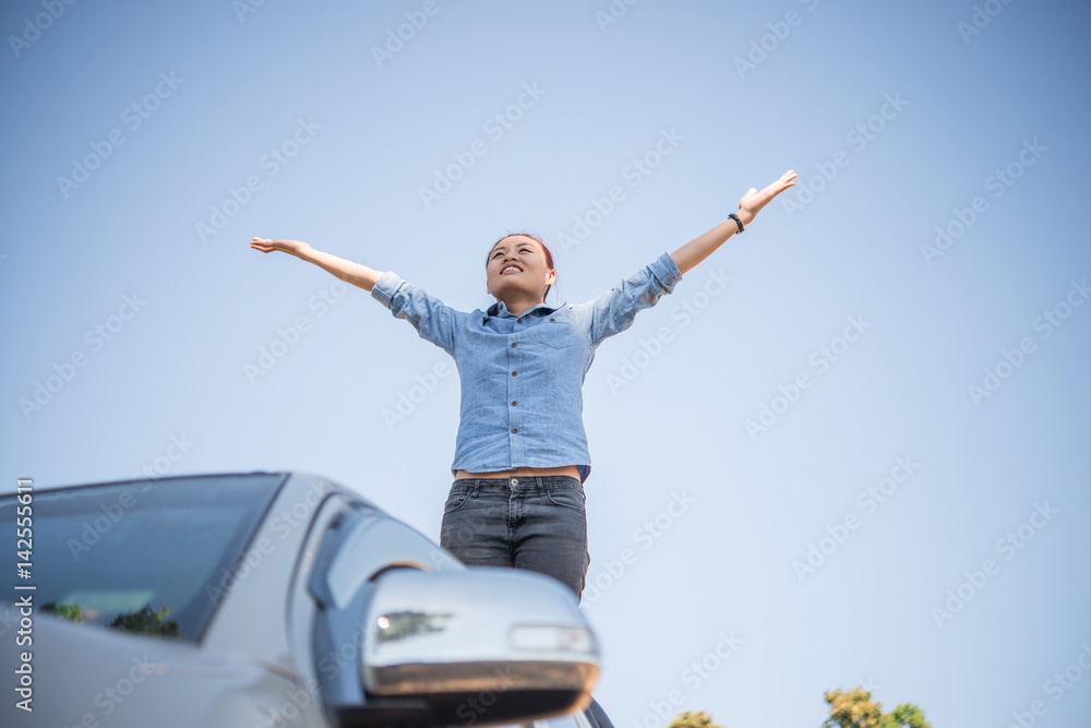 Young woman standing looking to a sky with raised hands while during hike in the mountain. Young woman standing looking to a sky with raised hands while during hike in the mountain.
