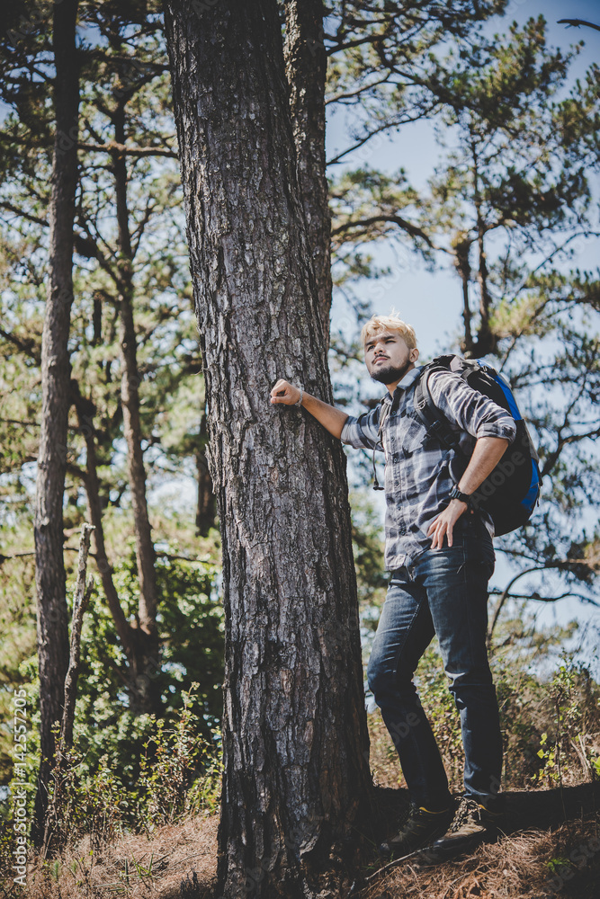 Young Man Traveler with backpack to mountain, Enjoying with nature around,Travel Lifestyle concept. Young Man Traveler with backpack to mountain, Enjoying with nature around,Travel Lifestyle concept.