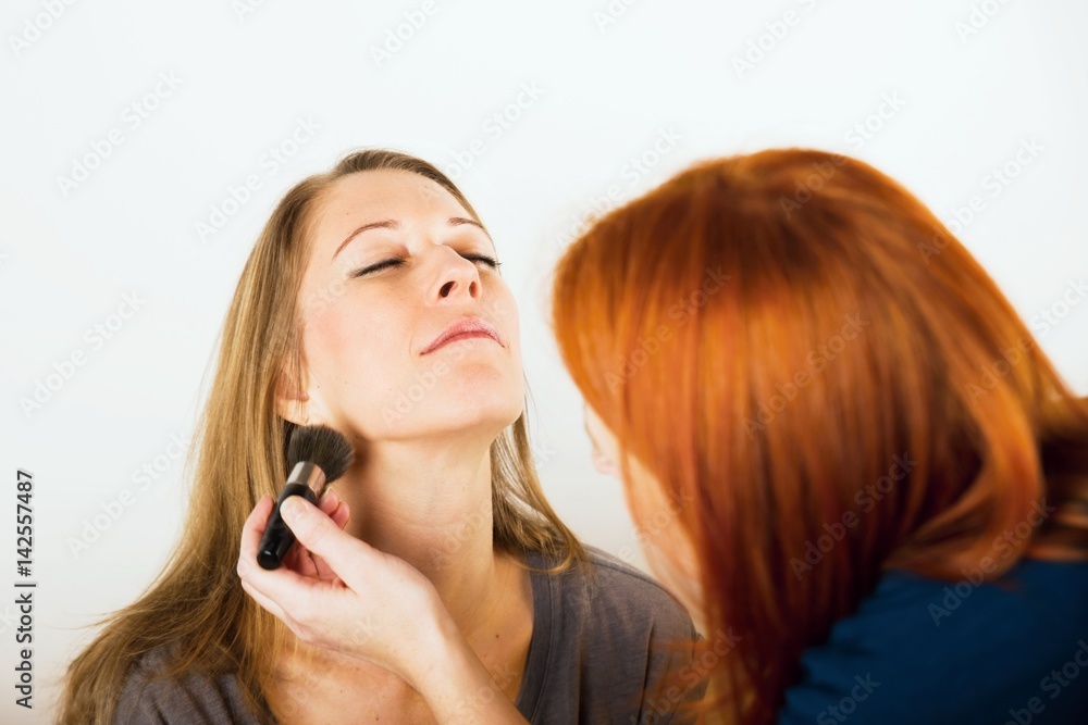 Fototapeta premium Two women applying make-up.